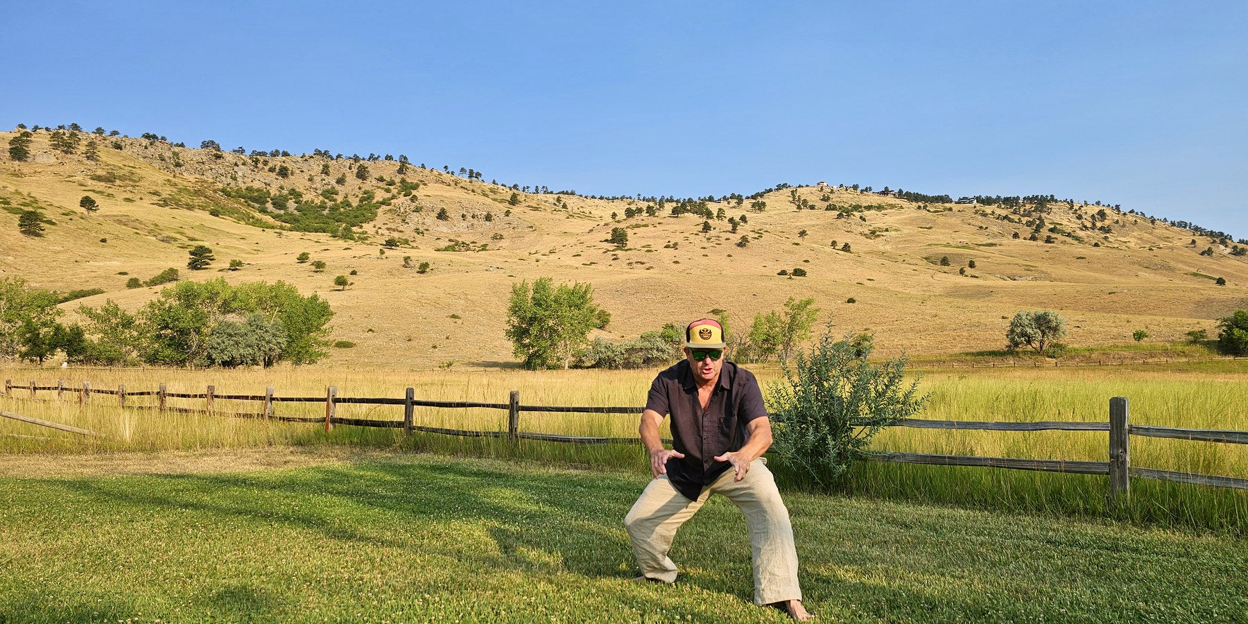 Stephen Joffe practising qigong in a Boulder field